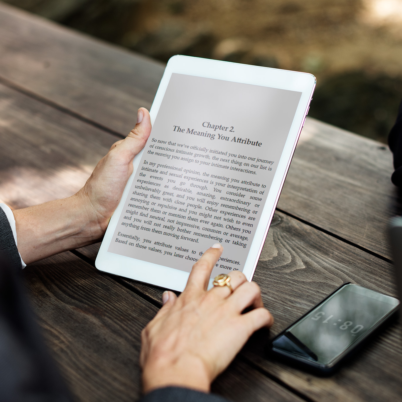 Woman reading an ePub eBook on her tablet out in the open.